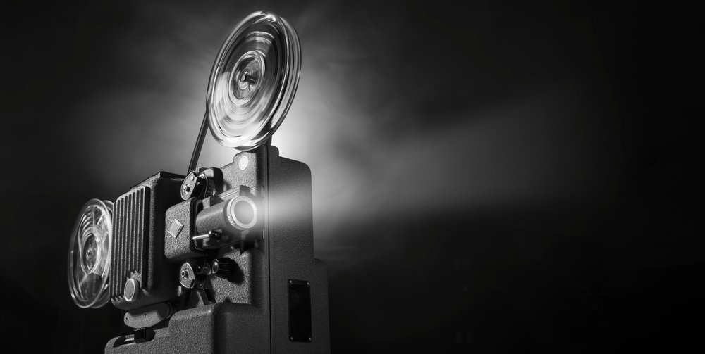 Cameraman silhouetted at a film camera